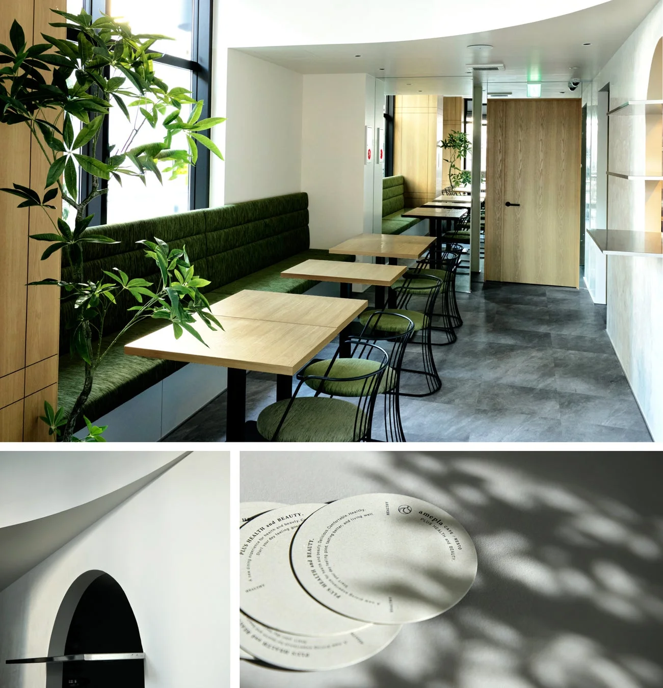 緑のベンチシートと木製テーブルが並ぶ、明るくモダンなカフェまたはレストランの店内