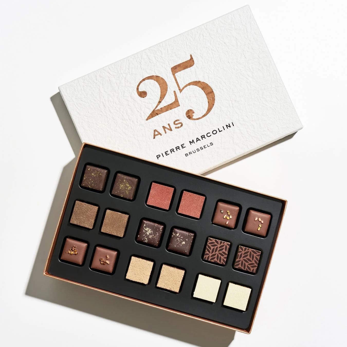 ピエールマルコリーニの25周年記念と思われる高級チョコレートの詰め合わせです。様々な種類の美しいプラリネが上品な箱に収められており、ギフトに最適です。